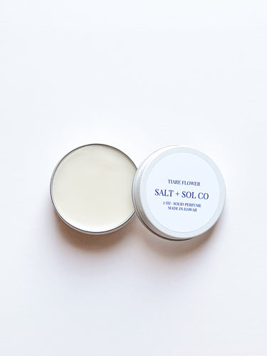 creamy solid balm with tiare flower scent inside open tin